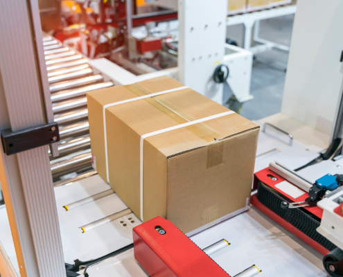 Side view of package about to be loaded onto conveyor belt in warehouse