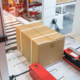 Side view of package about to be loaded onto conveyor belt in warehouse