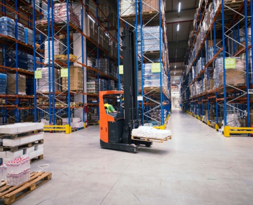 Industrial building large warehouse interior with forklift and palette