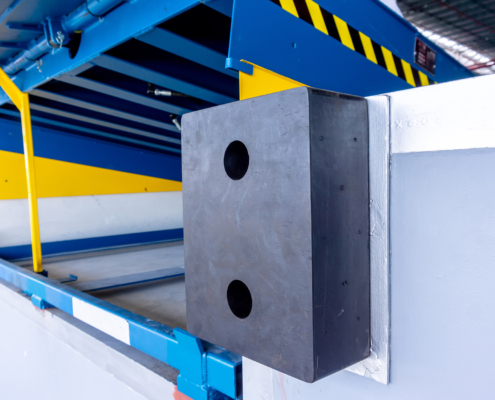 Loading dock leveler safety bumpers to keep trucks from harming the dock